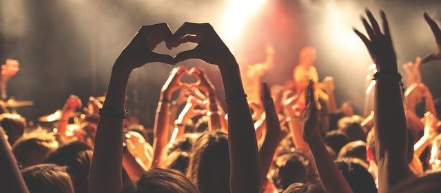 Concert audience making hearts with their hands